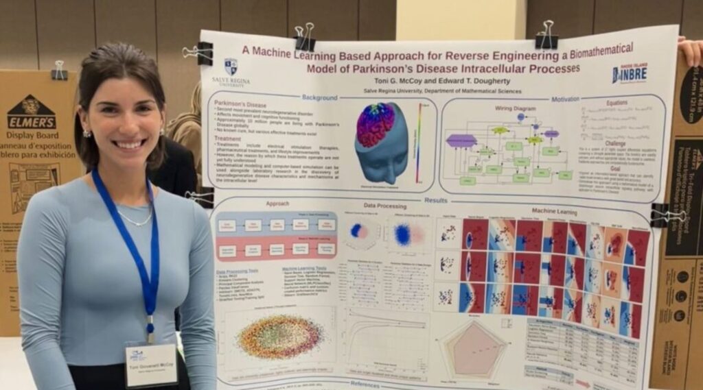 Toni McCoy stands in front of their poster "A Machine Learning Based Approach for Reverse Engineering a Biomathematical Model of Parkinson’s Disease Intracellular Processes"